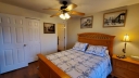 The master bedroom has a new Queen bed and a flat screen TV with Cable and Free Wi-Fi. The bathroom is privately off the bedroom. Walk out to the patio from the master bedroom.