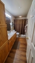 The master bathroom is privately off the master bedroom. There is a jetted tub/shower, blow dryer and more.