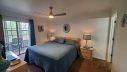 The master bedroom has a King bed, flat screen TV, cable, free Wi-Fi and a bathroom adjoining the bedroom. Walk out to the enclosed sun room to play a game of Checkers.