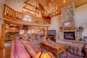 A great room welcomes you with hardwood floors, river stone accents, wood beams.