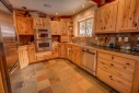 Granite tile counter tops, stainless steel appliances and a gas stove.