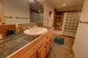 Master Suite 1 Bathroom features a slate tile steam shower, double sinks and a soaker tub.