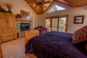 Master Suite 2 has a King Bed and a Flat Screen TV, Fireplace, Dish Satellite, and Internet. There is an adjoining bathroom. - Walk out to the deck from the bedroom.