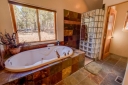 Master Suite 2 Bathroom features a slate tile steam shower, double sinks and a soaker tub.