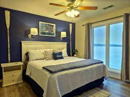 Experience unforgettable moments in this charming remodeled lake condo, complete with a king bed, a closet equipped with a dresser, hangers, and essential items like an iron and ironing board for your convenience.