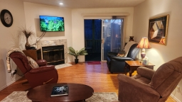 Unwind in this charming living room, featuring three inviting rocker recliners and a cozy couch that conveniently transforms into a sofa sleeper.
