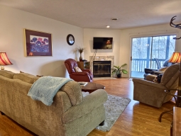 Unwind in this charming living room, featuring three inviting rocker recliners and a cozy couch that conveniently transforms into a sofa sleeper.