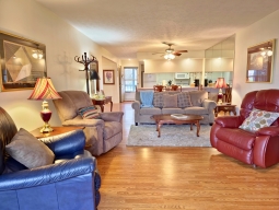 Unwind in this charming living room, featuring three inviting rocker recliners and a cozy couch that conveniently transforms into a sofa sleeper.