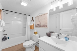 Enjoy a refreshing retreat in our bathroom, complete with a sleek sink, a relaxing bathtub with a shower, a toilet, and a hair dryer. Everything you need for a rejuvenating stay!