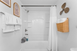 Our bathroom offers a perfect blend of comfort and convenience, featuring a chic sink, a nice bathtub with a shower, a toilet, and a hair dryer. Ideal for your relaxation and self-care needs! 